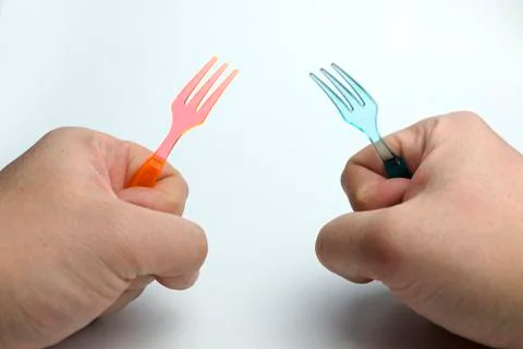 Hand holding a plastic fork. Stock Photos