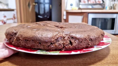 Hand Holding Plate with Round Chocolate Cake Stock Footage 321963567
