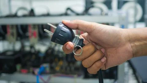 Hand holding plug have computer monitor in  the back, Concept Unplug bitcoin Stock Photos