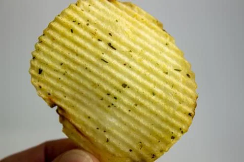 Hand holding Potato chips isolated on white background 스톡 사진