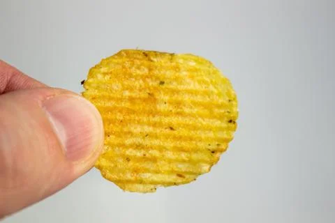 Hand holding Potato chips isolated on white background Stock Photos