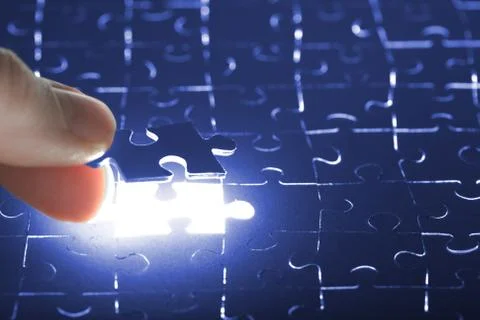 Hand holding puzzle piece Stock Photos