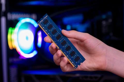 Hand holding ram memory chips inside gaming pc, symbolizing hardware shorta.. Stock Photos