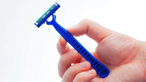 Hand holding a razor Stock Photos