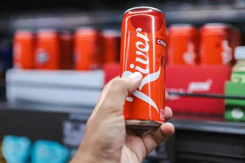 Hand Holding Red Cola Can in German Supermarket Stock Photos