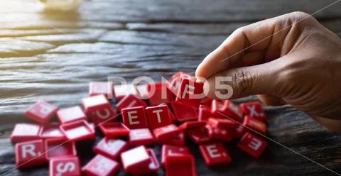 Hand holding red ETF text lay on a wooden floor, Concept Guidelines for Digit Stock Photos