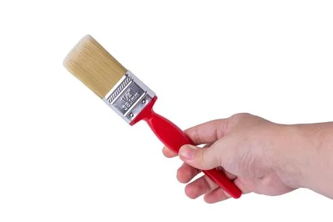 Hand holding a red handle paint brush against a white background Photos