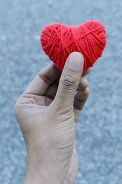 Hand holding Red heart shape made from thread yarn for Love Valentine's day Stock Photos