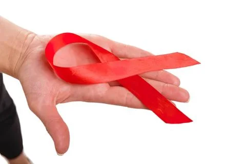Hand holding red ribbon loop on white background Stock Photos