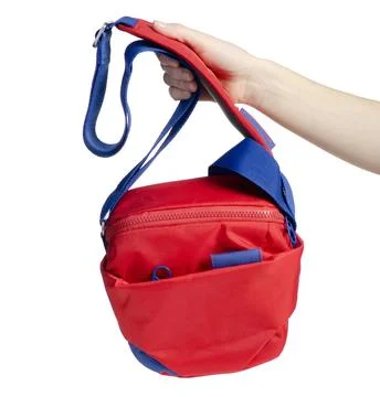 Hand holding red shoulder camera bag Photos