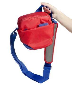 Hand holding red shoulder camera bag Photos