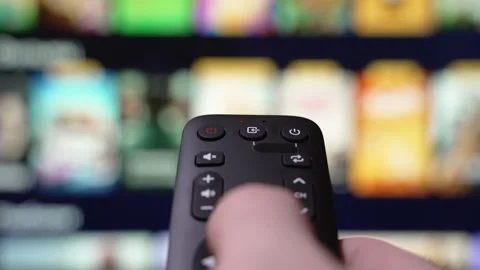 Hand Holding a Remote Control Browses Various Streaming Services Video stock 292865007