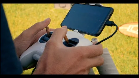 Hand holding a remote control for drone piloting Stock Footage 94232022