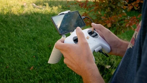 Hand holding a remote control for drone piloting Stock Footage 94232945