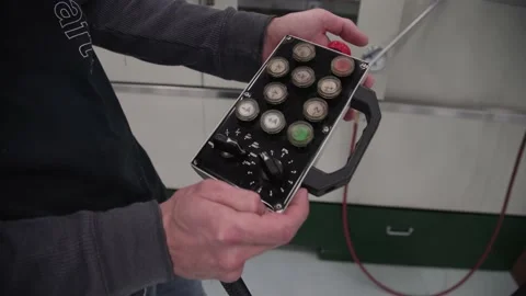 A hand holding a remote control Stock Footage 155537769