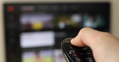 Hand holding remote control in front smart TV Stock Footage 116200758