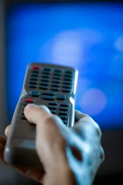 Hand holding a remote control Stock Photos