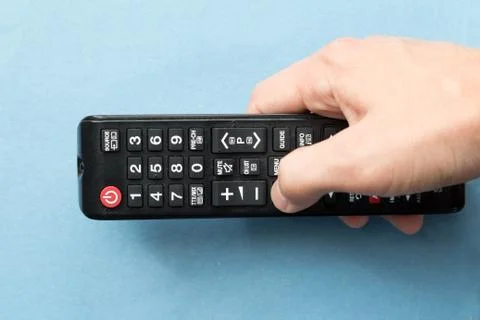 Hand holding remote control Stock Photos