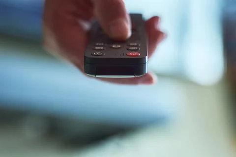Hand holding a remote control Foto stock