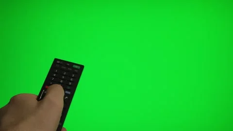 Hand holding remote control pointing at green screen TV mockup. Stock Footage 340556458