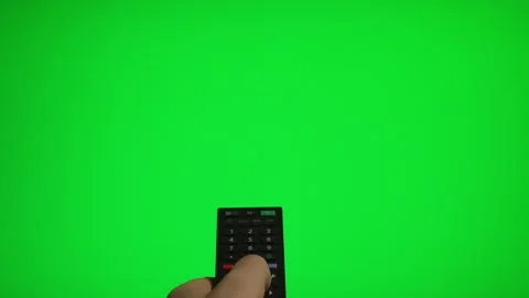 Hand holding remote control pointing at green screen TV mockup. Stock Footage 340556459