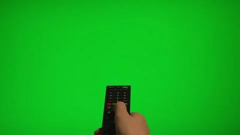 Hand holding remote control pointing at green screen TV mockup. Stock Footage 340556468