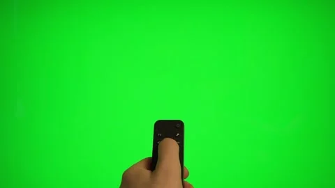 Hand holding remote control pointing at green screen TV mockup. Stock Footage 340556481