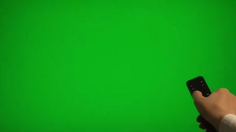 Hand holding remote control pointing at green screen TV mockup. Stock Footage 340556485