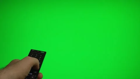 Hand holding remote control pointing at green screen TV mockup. Stock Footage 340556507