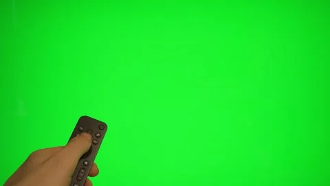 Hand holding remote control pointing at green screen TV mockup. Stock Footage 340556514