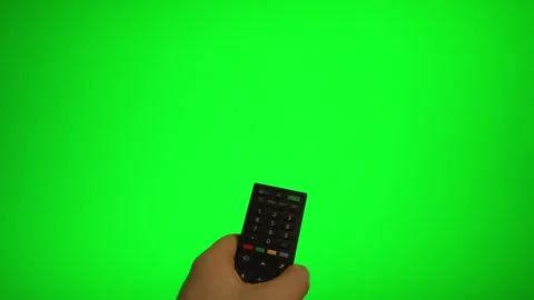 Hand holding remote control pointing at green screen TV mockup. Stock Footage 340556518
