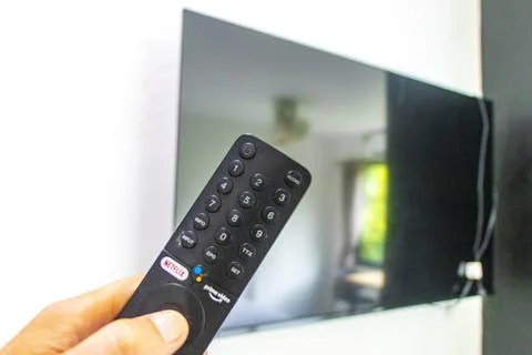 Hand Holding Remote Control Turning On Television In Thai Hotel Room Thailand Stock Photos