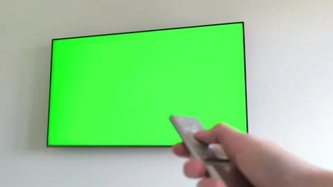 Hand holding a remote control turns on a television showing a loading circl.. Stock Footage 337172288