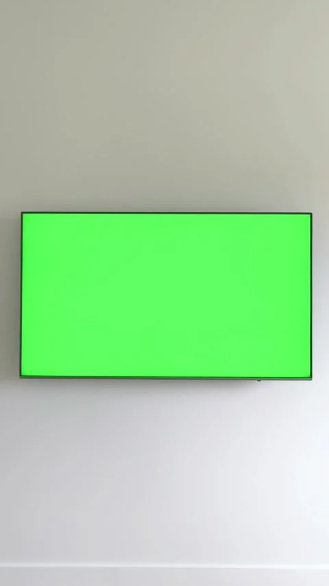 Hand holding a remote control turns off a television with a green chroma ke.. Stock Footage 337172295