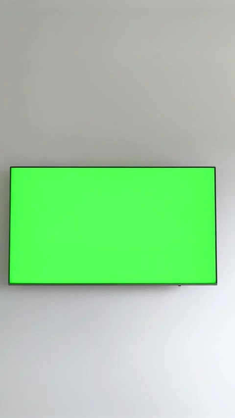 Hand holding a remote control turns on a television as a green chroma key s.. Stock Footage 337774207