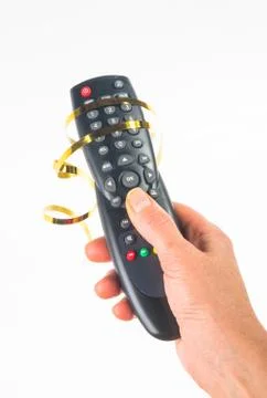 Hand holding a remote control on white background, close-up Stock Photos