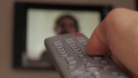 Hand Holding Remote TV Controller Towards Working Televison Stockbeeldmateriaal 85123589