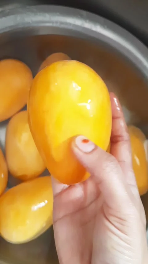 Hand Holding Ripe Mango and Showing Fruit Quality Close Up Stock Footage 336545212