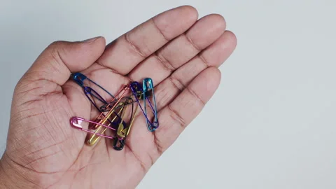 A Hand Holding Safety Pins Stock Footage 248765074