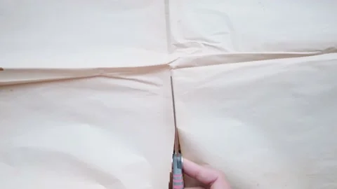 The hand holding scissors cut old paper on the desk Stock-Footage 148101458