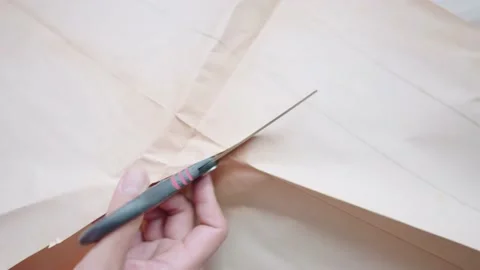 The hand holding scissors cut old paper on the desk Stock Footage 148101464