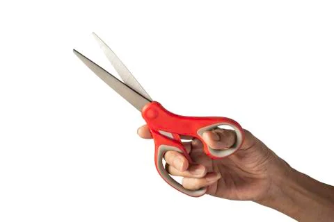 Hand holding a scissors with red plastic handle and clipping path isolated on Stock Photos