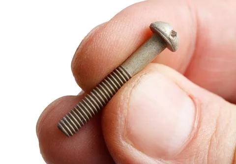 A hand holding a screw with a missing head 写真素材