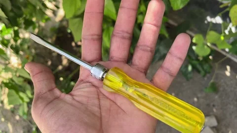 Hand Holding Screwdriver Closeup – DIY Repair and Maintenance Concept Video Видео 318840332