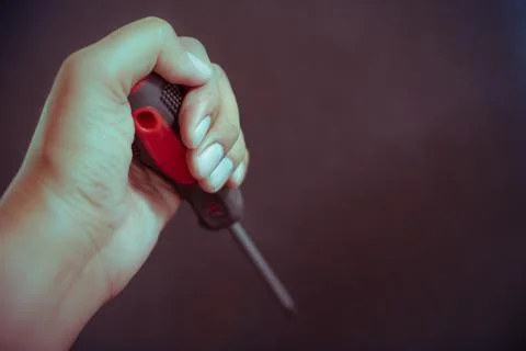 Hand holding screwdriver Stock Photos