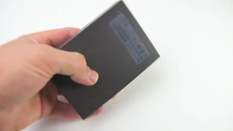 Hand holding Seagate hard disk drive external storage with 5 terabytes memory Stock Footage 179152499