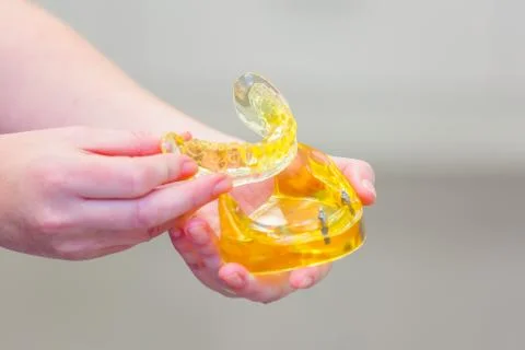 Hand holding a set of dentures Stock Photos