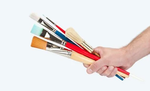 Hand holding several brushes Stock Photos