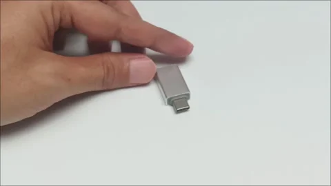 Hand holding silver metallic usb type c adapter converter Stock Footage 340861146