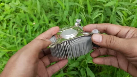 A hand holding a silver object with a black knob Stock Footage 295652451